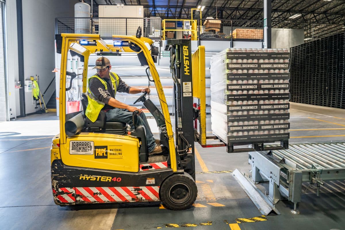 Forklift loading pallets in a warehouse