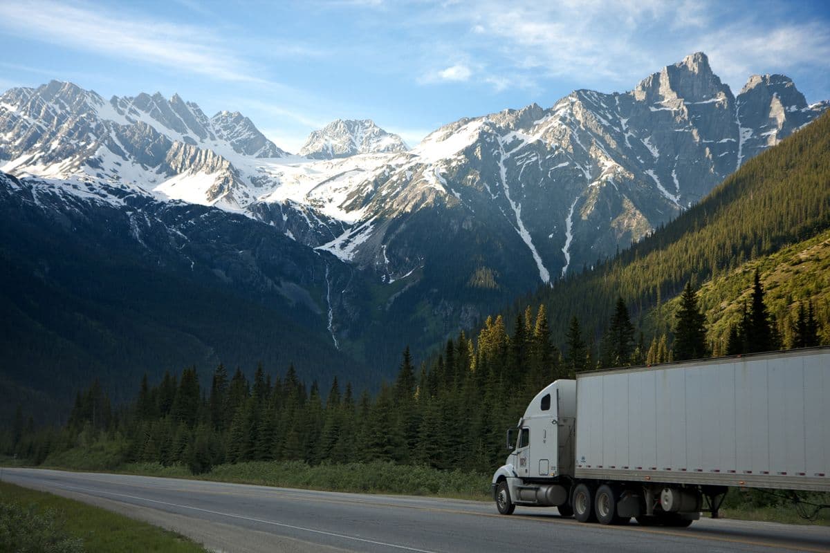 White semi-trailer on a mountain highway